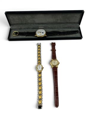a couple of watches are sitting in a box on a white surface