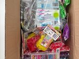 a cardboard box filled with assorted toys and other items