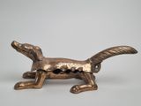 bronze figurine of a dachshund on a white background