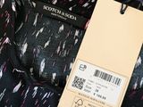a close up of a black and pink dress with a tag on it