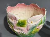 a small bowl with flowers painted on it next to a smaller bowl with flowers painted on it