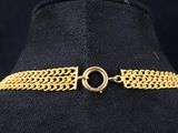 a close up of a gold chain choke on a mannequin