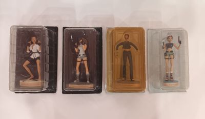 three plastic figurines of a man and a woman on display