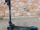a scooter that is sitting on the sidewalk
