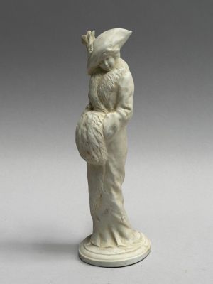 a white figurine of a woman holding a bird