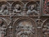 a wooden chest with carvings of people and animals on it