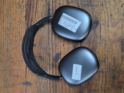 two black headphones that are on a wooden table