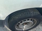 a white van with a flat tire on the street