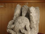 a stone sculpture on a red cloth on a table