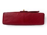 a red purse with a gold clasp on it