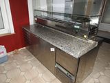 an image of a kitchen with a counter top and a refrigerator