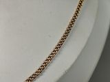 a close up of a gold chain necklace on a mannequin