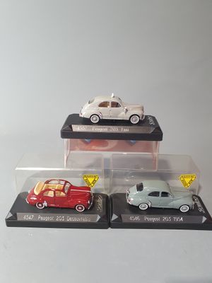 three different models of cars are on display in a display case