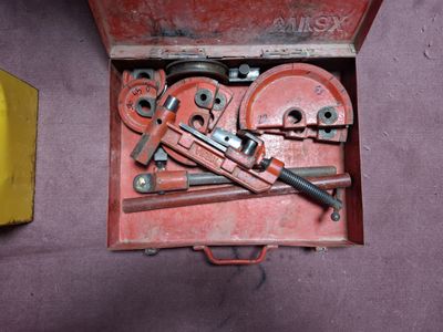 a red box with tools inside of it on a purple surface