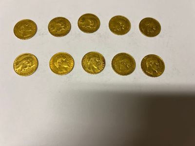a close up of a bunch of gold coins on a table