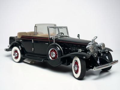 a model of a black car on a white surface