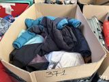 a cardboard box full of clothes on a red table