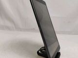 a close up of a tablet computer on a stand on a white surface