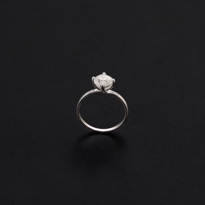 a close up of a diamond ring on a black surface