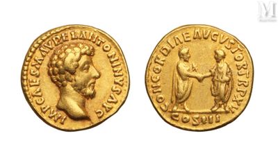 a gold coin with a bust of a man and a woman on it
