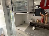 a small kitchen with a microwave and refrigerator in it