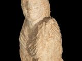 an old statue of a woman with her hands on her chest