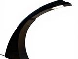the black lamp is on a white surface with a white background
