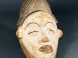 an image of a wooden mask on a gray background