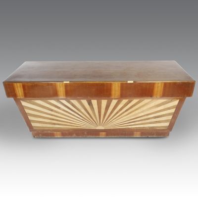 a wooden box with a sun design on the top