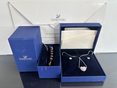 a blue box with a necklace and earring in it