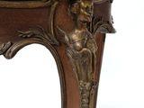 a wooden table with a carved top on a white background