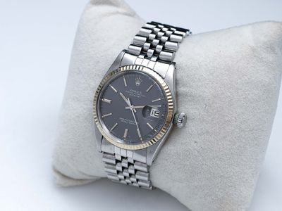 une photo d'une montre-bracelet posée sur un oreiller, sur une surface blanche