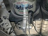 two bottles of beer sitting on top of a counter