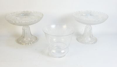 three glass bowls and a glass cup on a table
