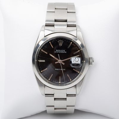 an image of a wrist watch with a black dial on a silver bracelet