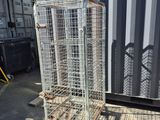 an image of a metal cage with wheels in front of a shipping container