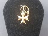 a close up of a small gold star charm on a black display case