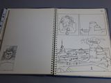 someone is drawing a picture in a book on a table