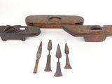 three pieces of old tools are sitting on a white surface
