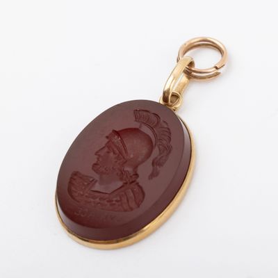 a close up of a pendant with a picture of a woman on it