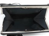 black leather clutch bag with silver metal frame and handle
