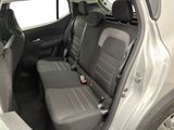 the back seats of a car with a remote control in the passenger seat