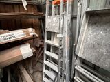 a pile of wood in a room with a ladder
