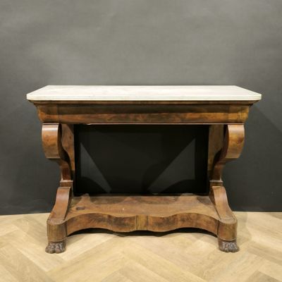 a wooden table with a marble top on top of a wooden floor