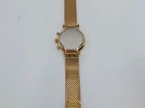 a close up of a gold wrist watch on a white surface