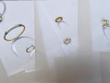 many different types of wedding rings displayed on a table