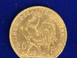 l'image d'une pièce d'or ornée d'un coq