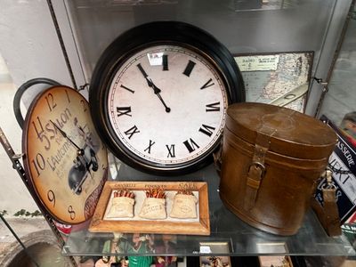 a glass table topped with a clock and other items