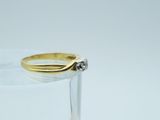 a close up of a gold and silver ring on a clear glass