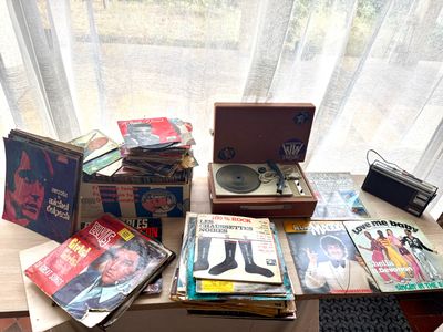 a table with a record player, record player, and other items on it